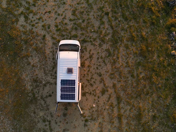 Camper vans parked at a scenic Danish location, with a focus on new tourism regulations