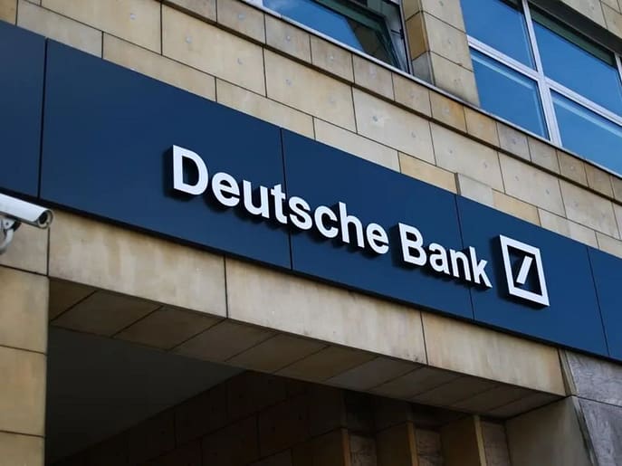 Deutsche Bank building with Postbank logo in the background, symbolizing the ongoing legal dispute over the acquisition