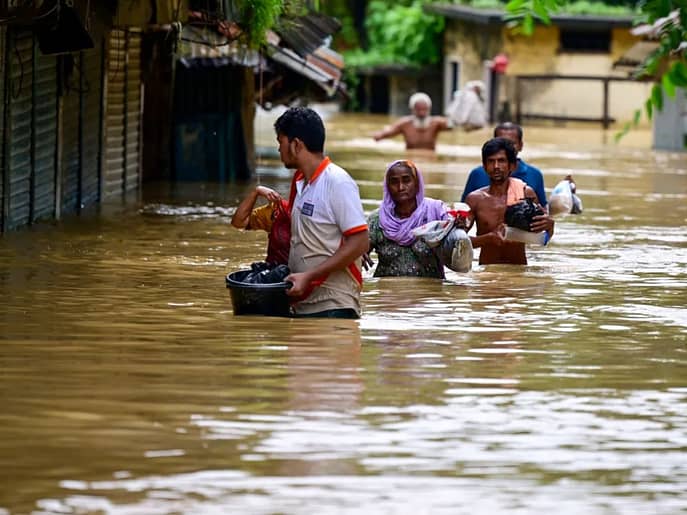 Flooded homes in Sherpur, Bangladesh, with rescue operations underway amidst heavy rainfall